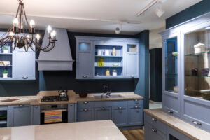 Stylish kitchen in blue tones with elegant chandelier